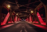 red and black metal bridge during nighttime