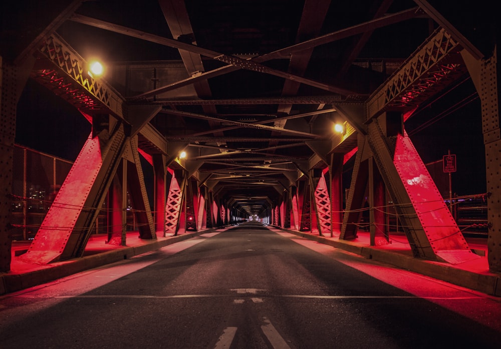 red and black metal bridge during nighttime