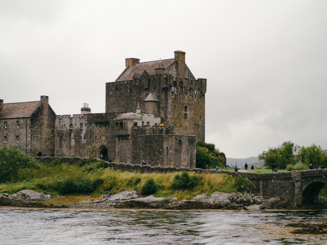 castle and bridge near body of water