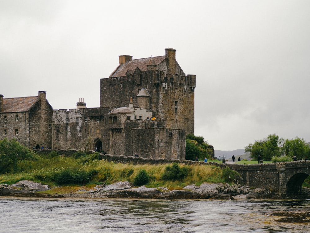 castle and bridge near body of water