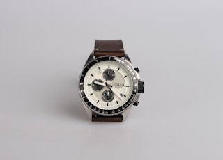 round silver-colored Fossil chronograph watch at 9:22 with brown leather band