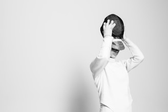 person holding black cap