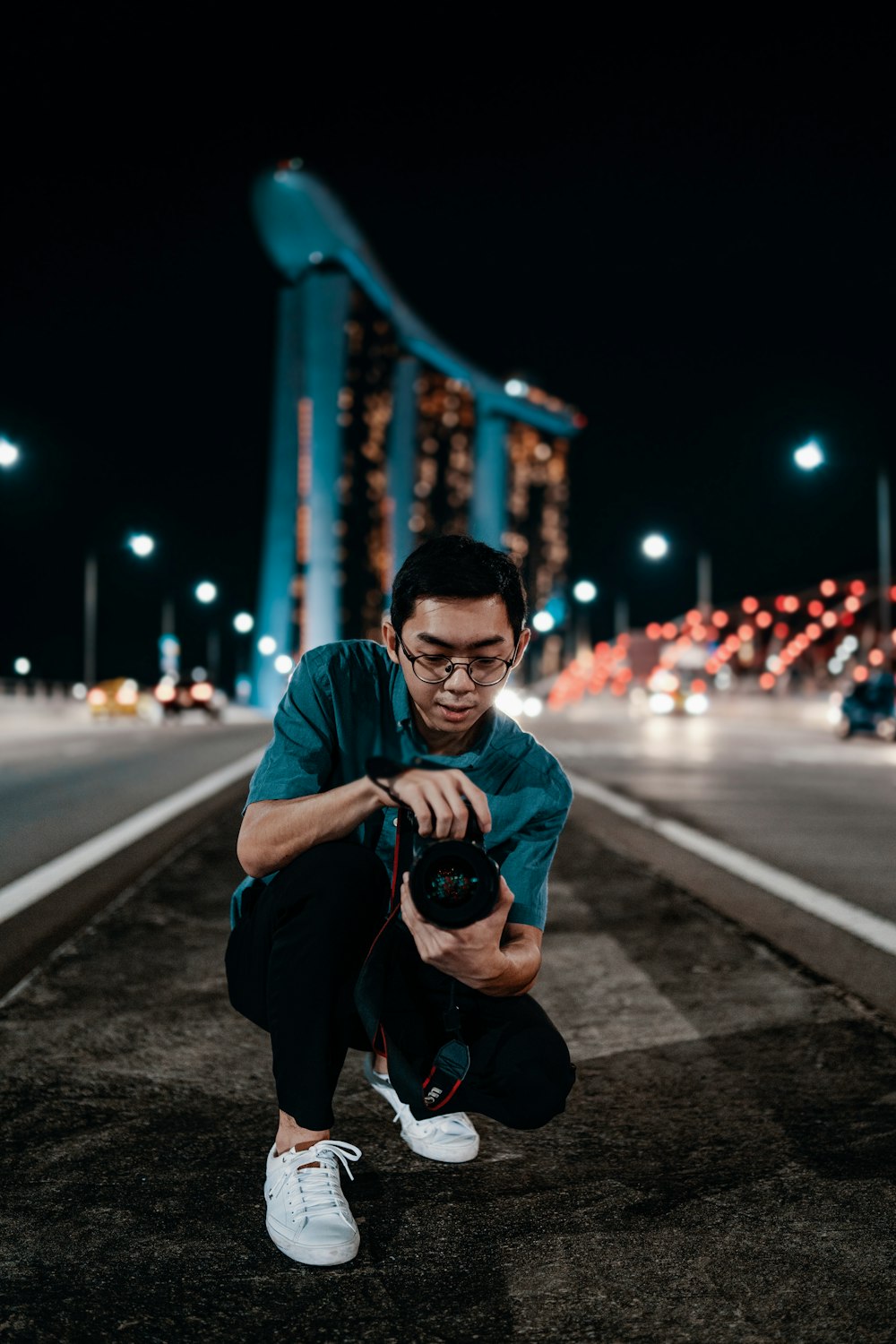 man holding camera during nighttime