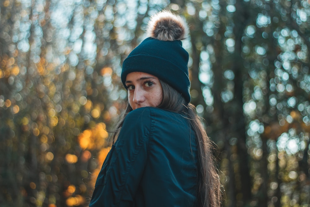 woman in bobble hat and black jacket