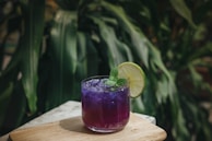 A refreshing Amethyst Beverage being poured into a glass with ice.