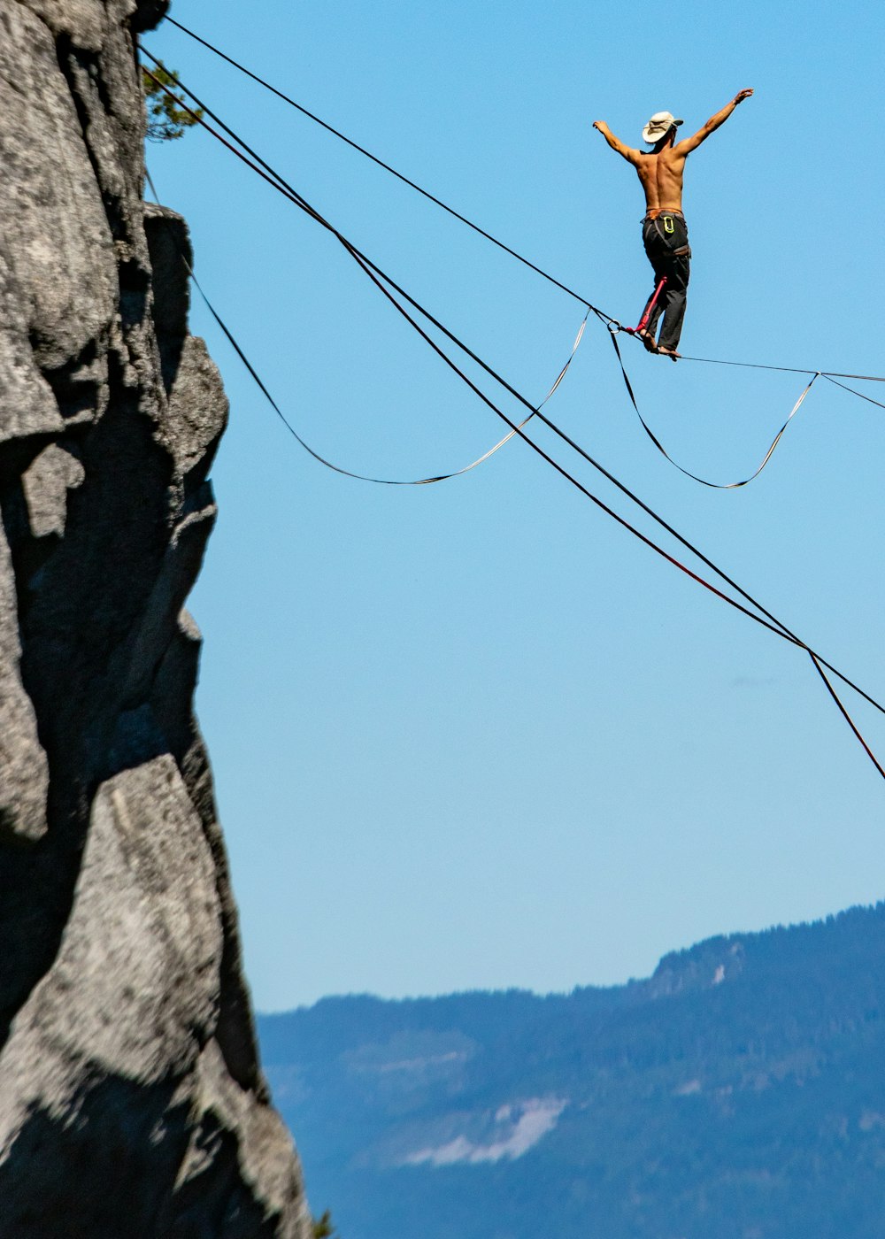 man standing on ropes