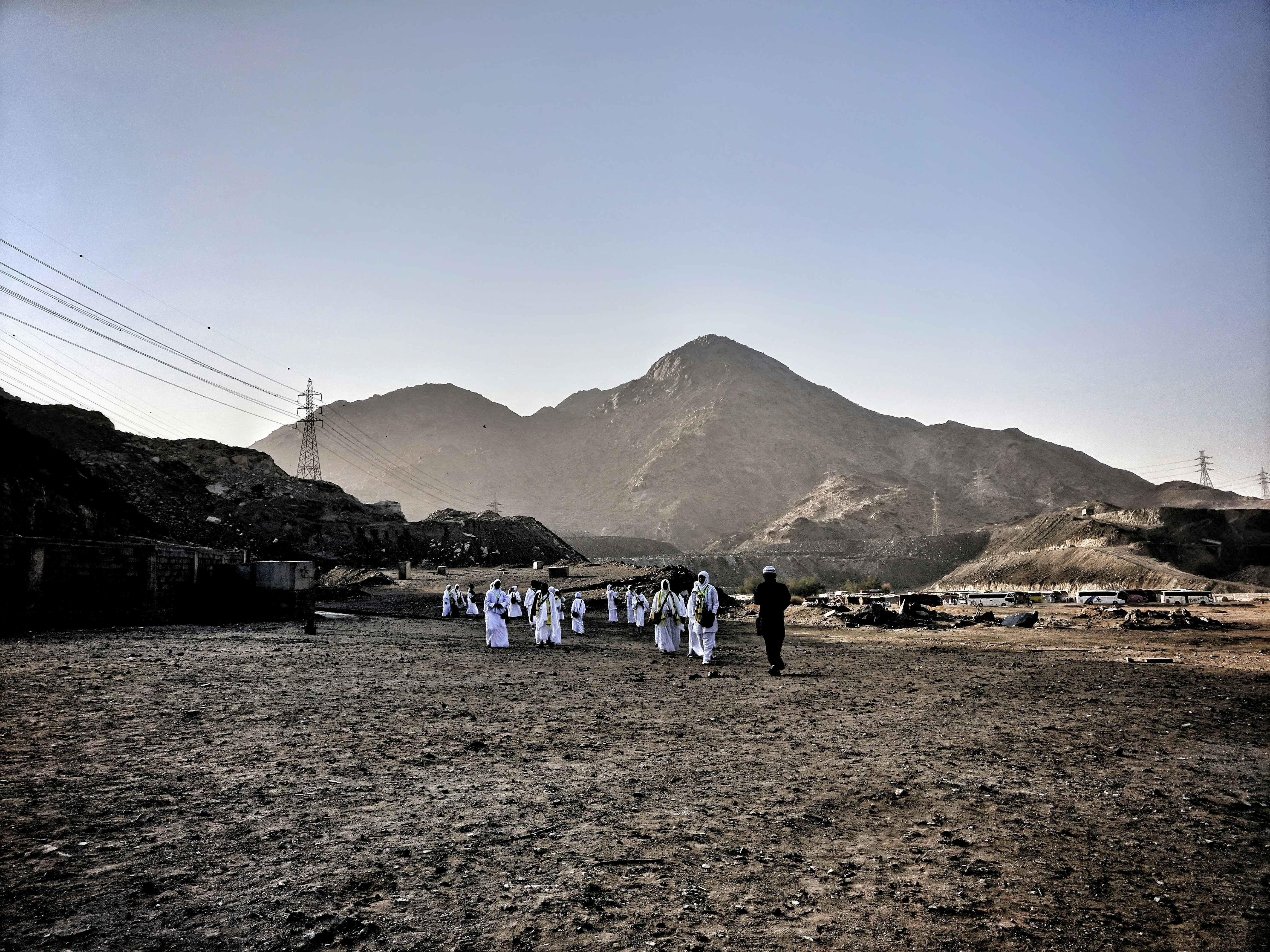 people walking beside electric tower during daytime