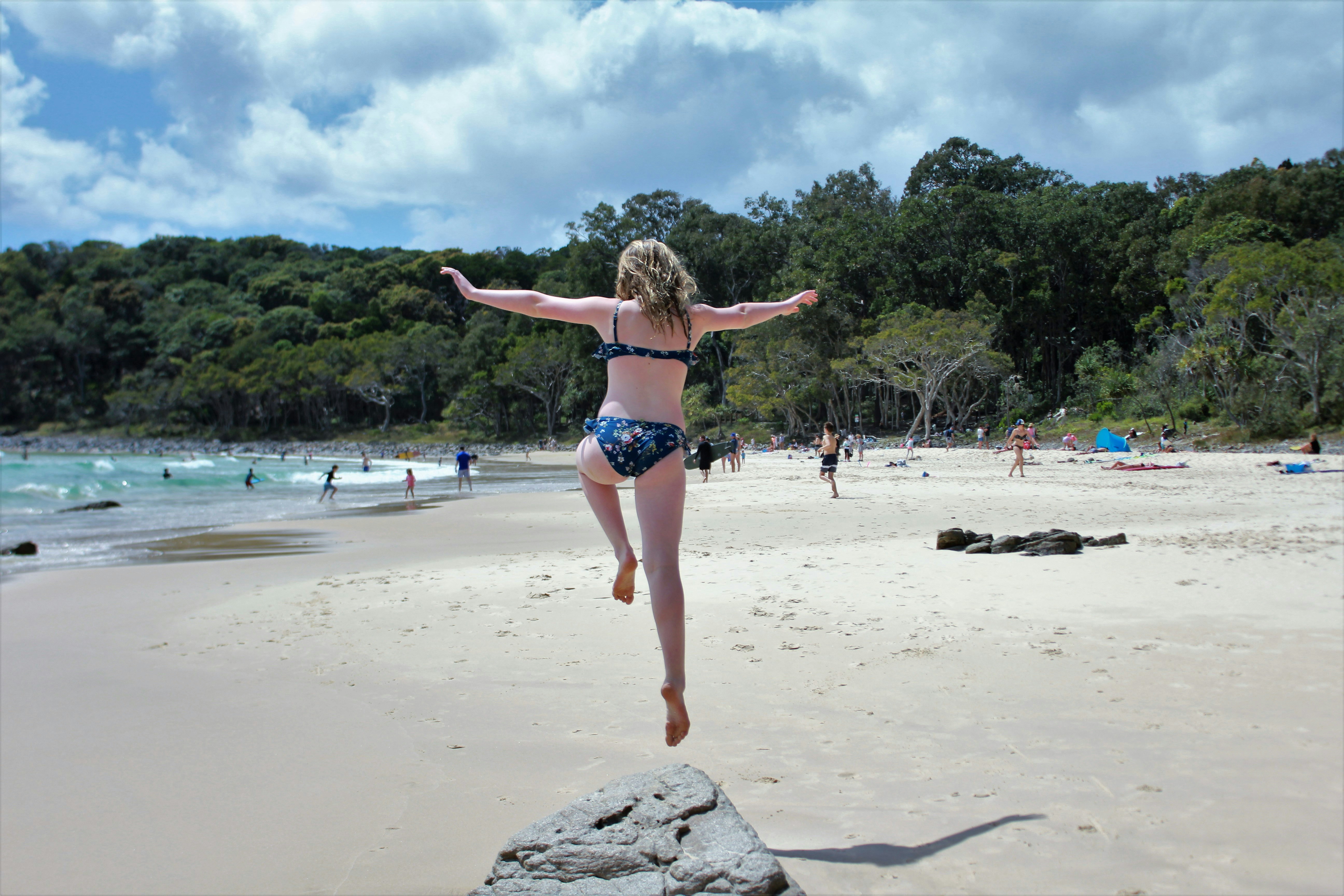 Woman In Bikini Jumping On Shore Photo Free Person Image On Unsplash