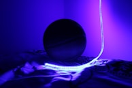 Close-up of a basketball spinning above a glowing court floor with #6f0e04 highlights.