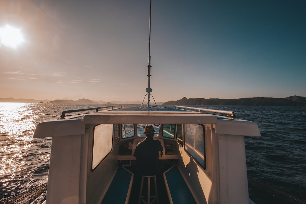 man riding yacht photography