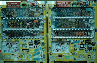 a vending machine with lots of stickers on it