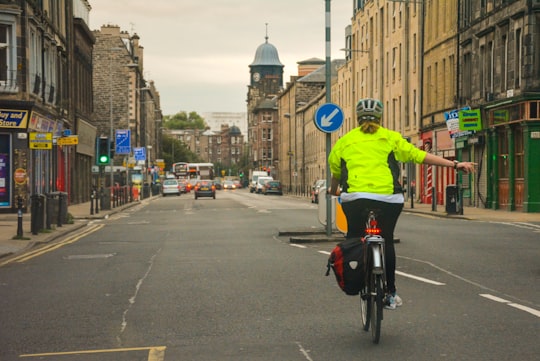 woman riding bike on road in Edinburgh United Kingdom