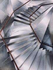 Close-up of a sleek, custom-designed metal staircase with clean lines and a brushed finish.