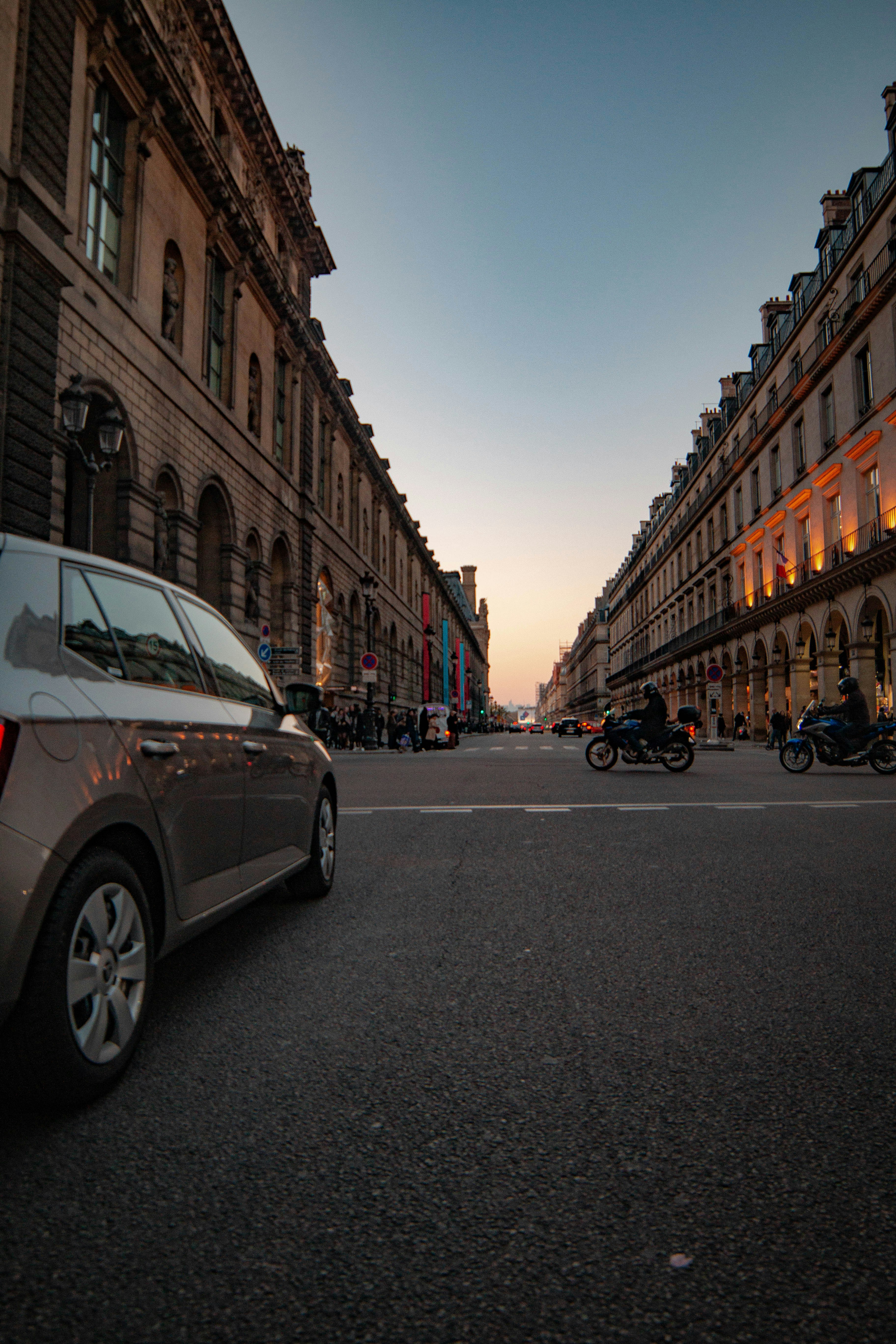 silver vehicle in road during golden hour