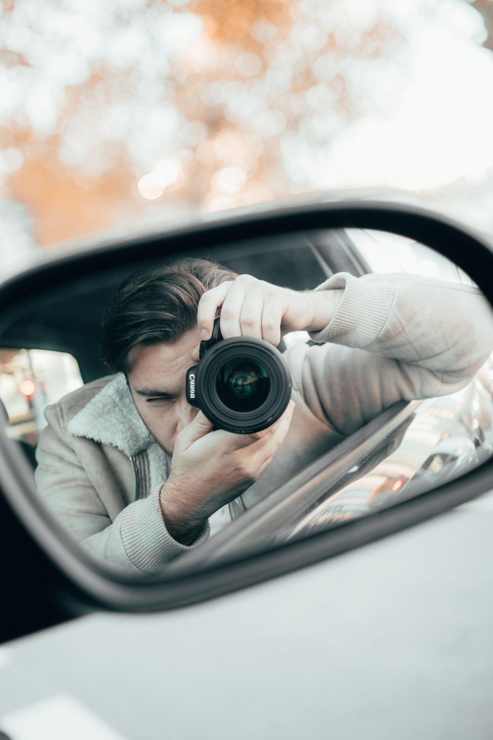 man holding black camera during daytime