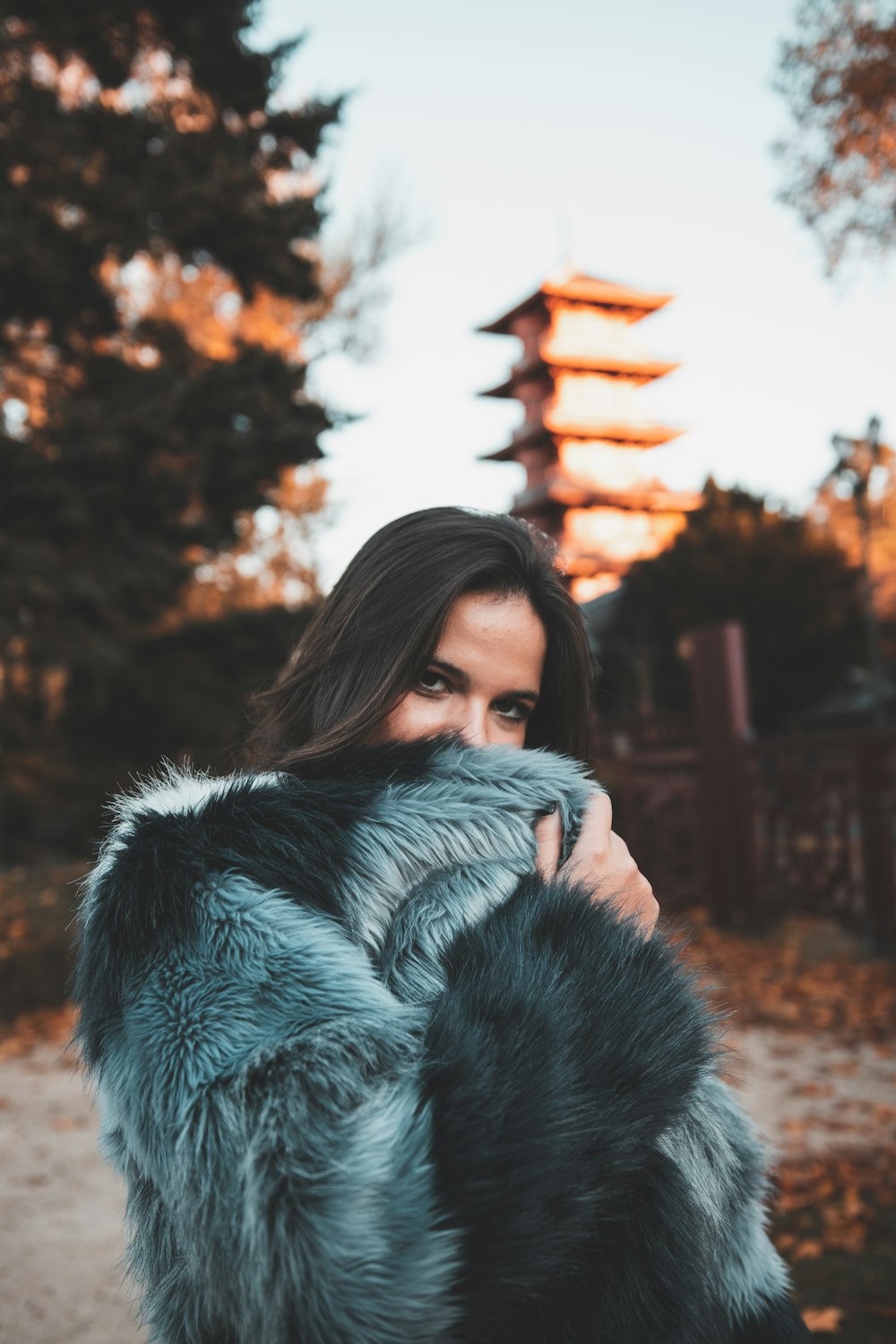 woman in gray and black fur coat standing