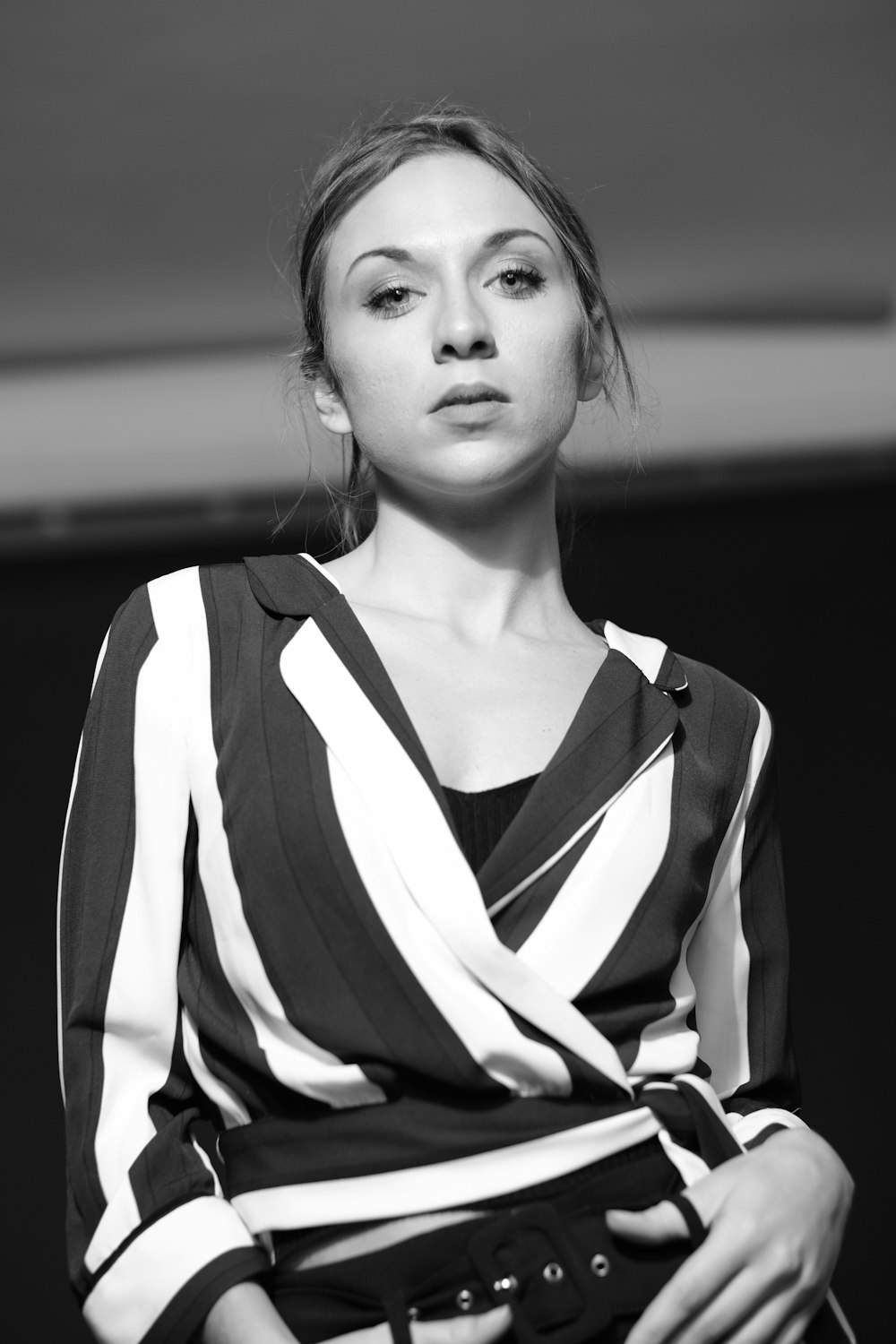 grayscale photography of woman wearing V-neck long-sleeved dress