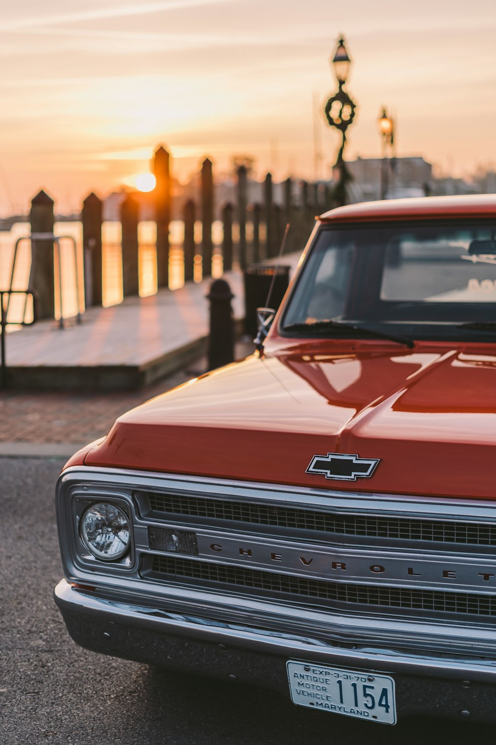 red Chevrolet vehicle parked during daytime