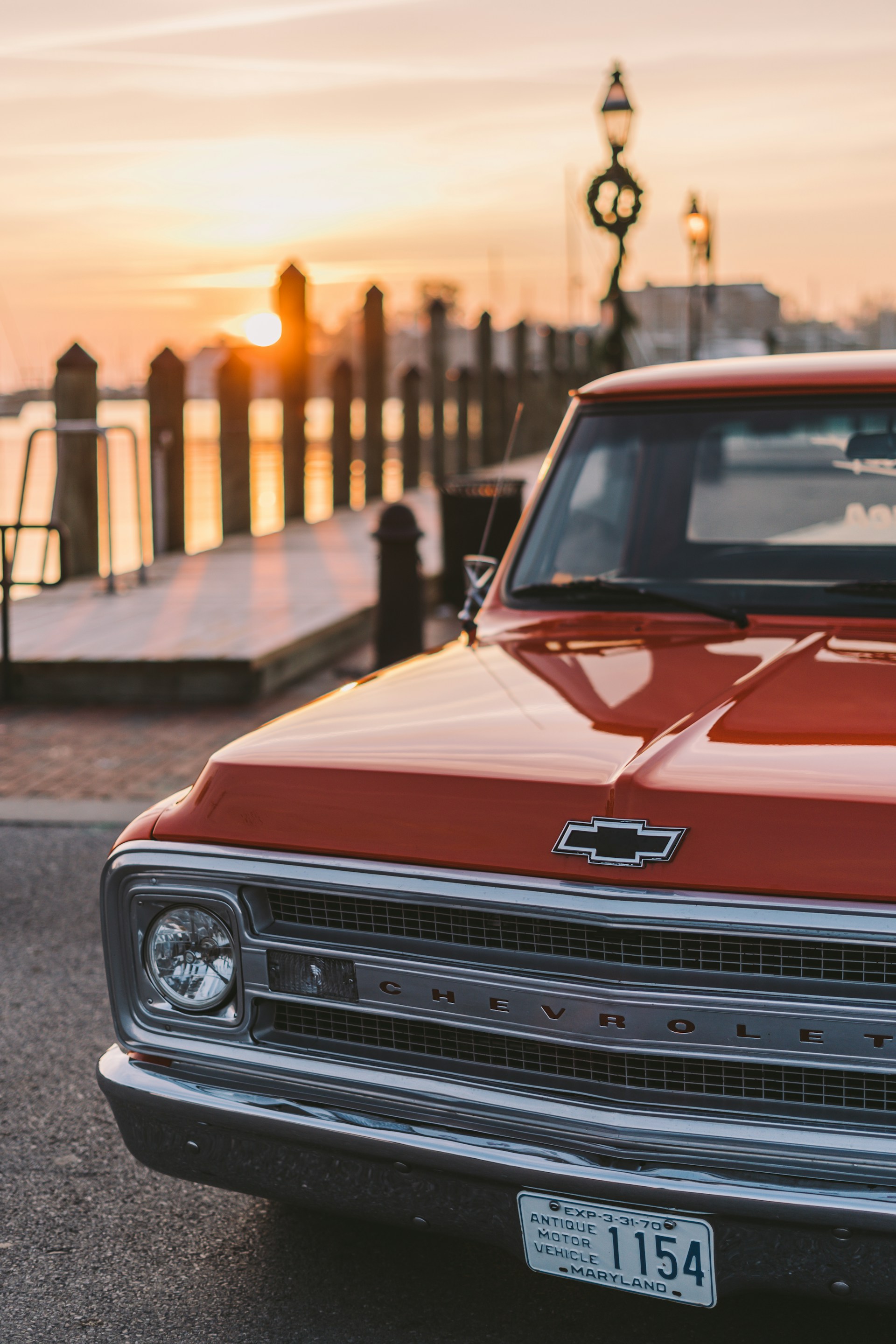 red Chevrolet vehicle parked during daytime