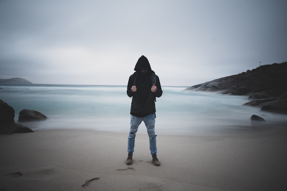 man standing on seashore