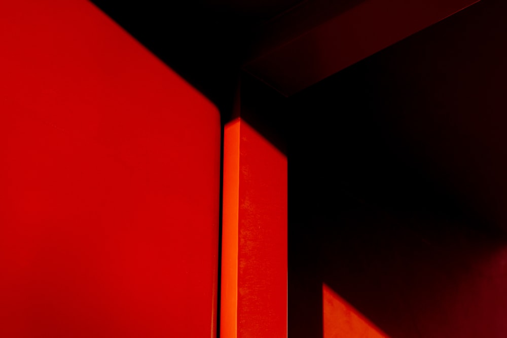 a close up of a red wall with a clock on it