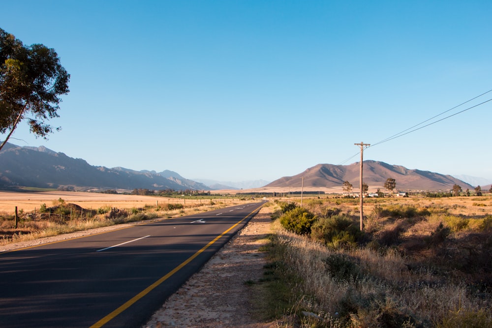 empty gray concrete road during daytime