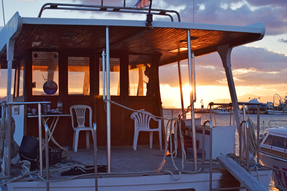 two white plastic chairs in boat