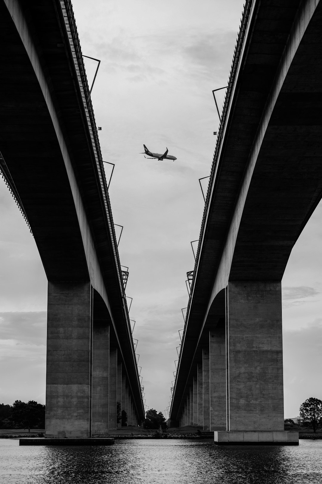 grayscale photo of concrete bridge