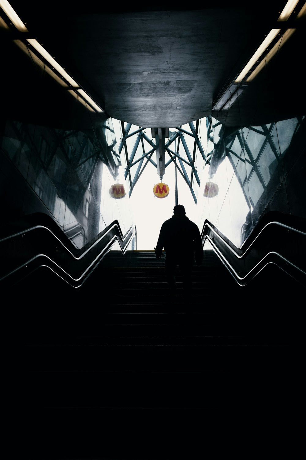 person walking inside stairs during daytime