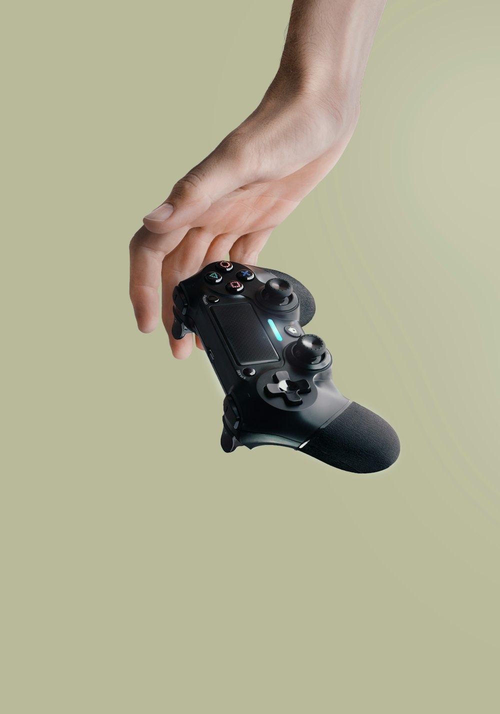 person holding Sony DualShock 4 wireless controller