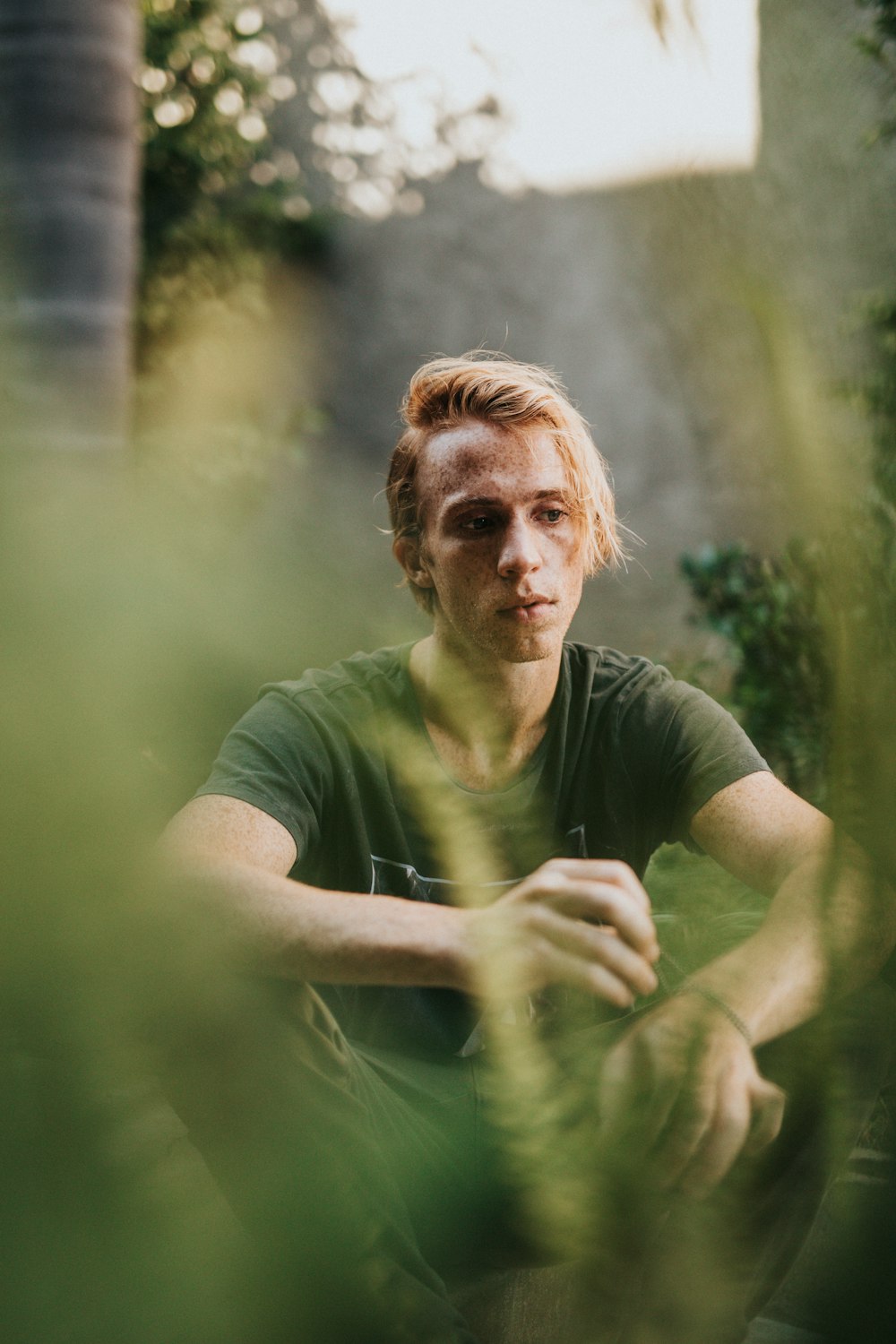 man sitting near trees