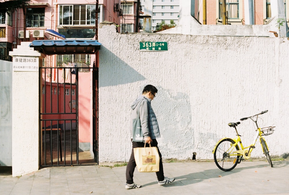 man holding beige paper bag