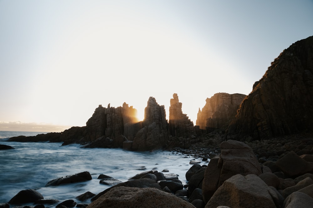 stone formations on ocean during daytime