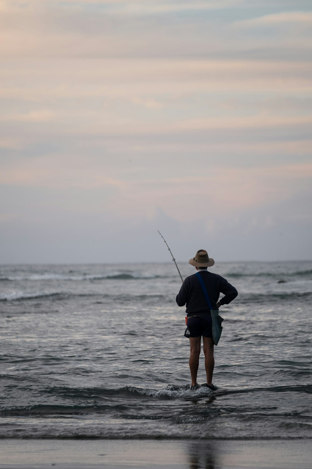 fishing person in black long-sleeved top during golden hour
