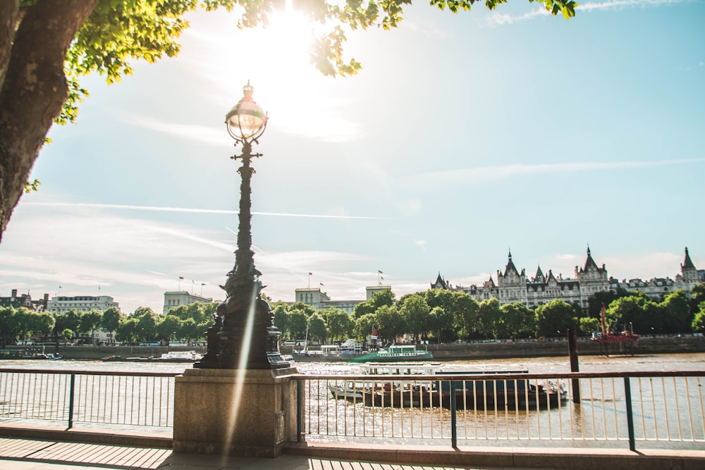 a lamp post on the side of a river