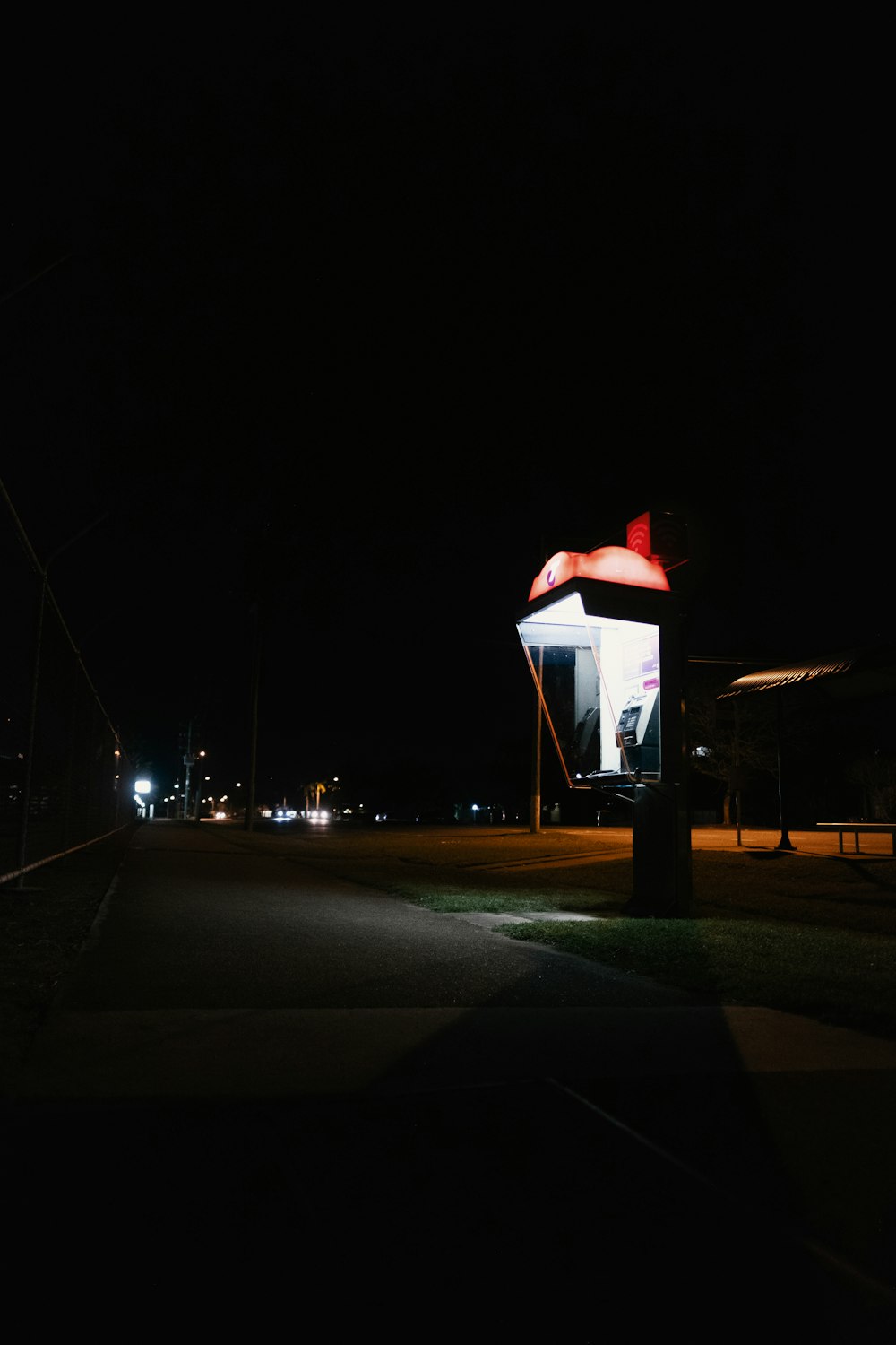 a dark street at night with a light on