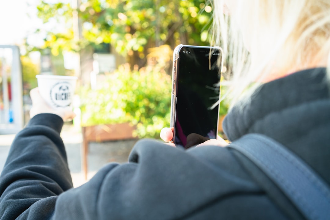 woman taking photo of white disposable cup