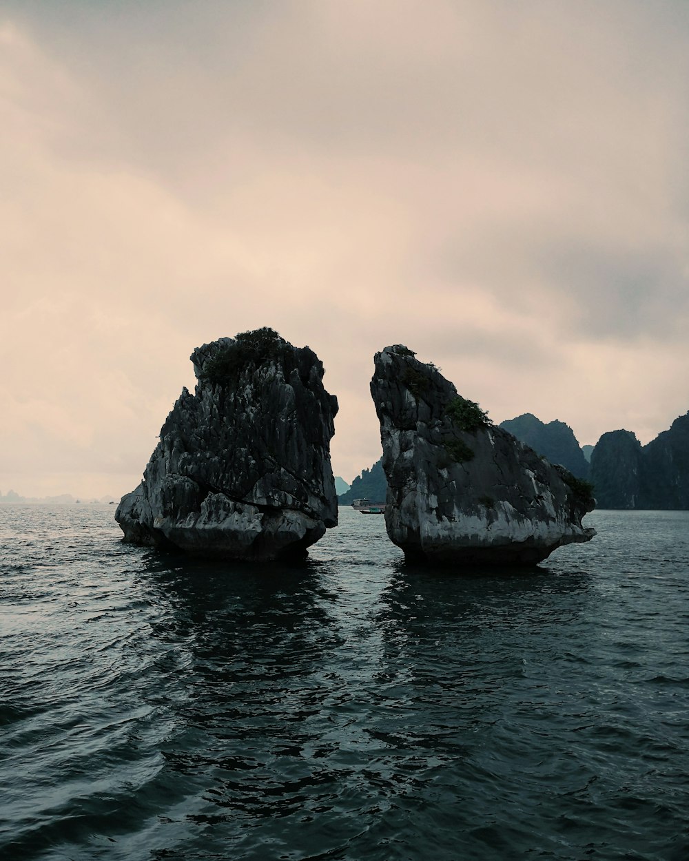 gray rock formation at water during daytime