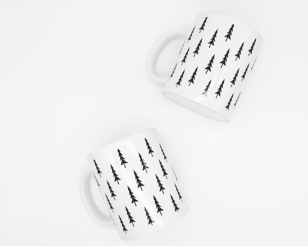 two white-and-black trees print ceramic mugs
