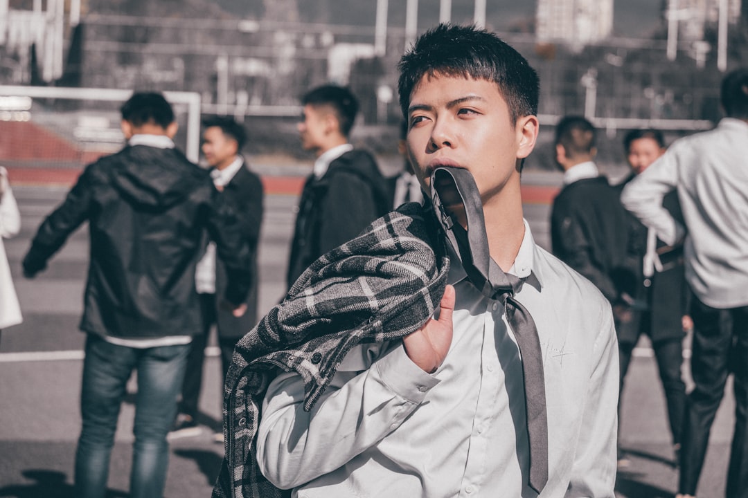 man biting shirt close-up photography