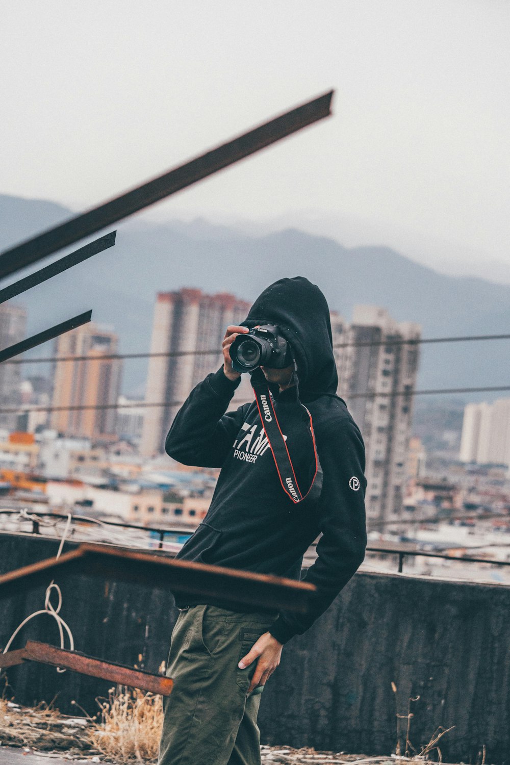 standing person holding DSLR camera during daytime