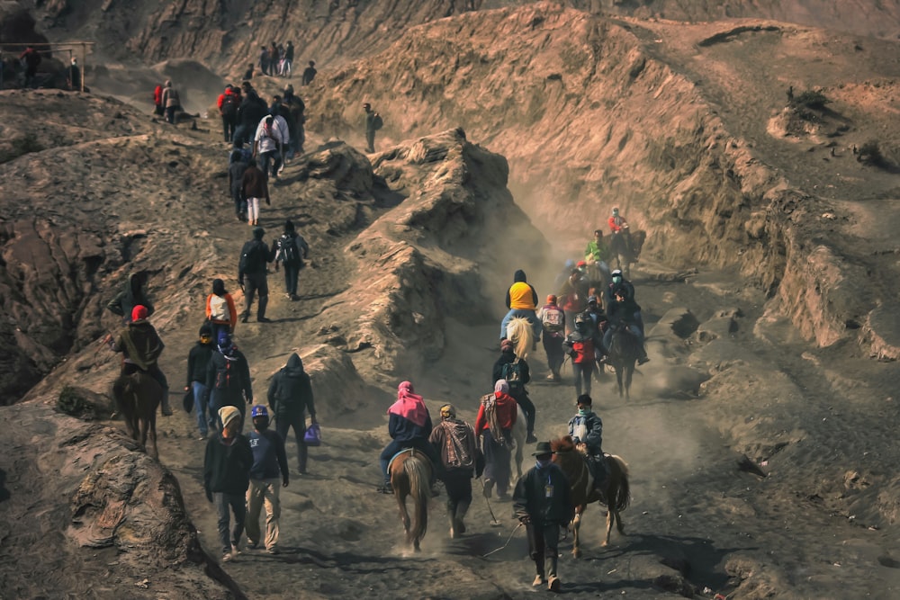 group of people walking towards mountian