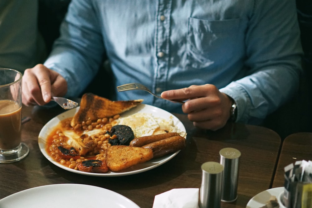 person eating bread with beans