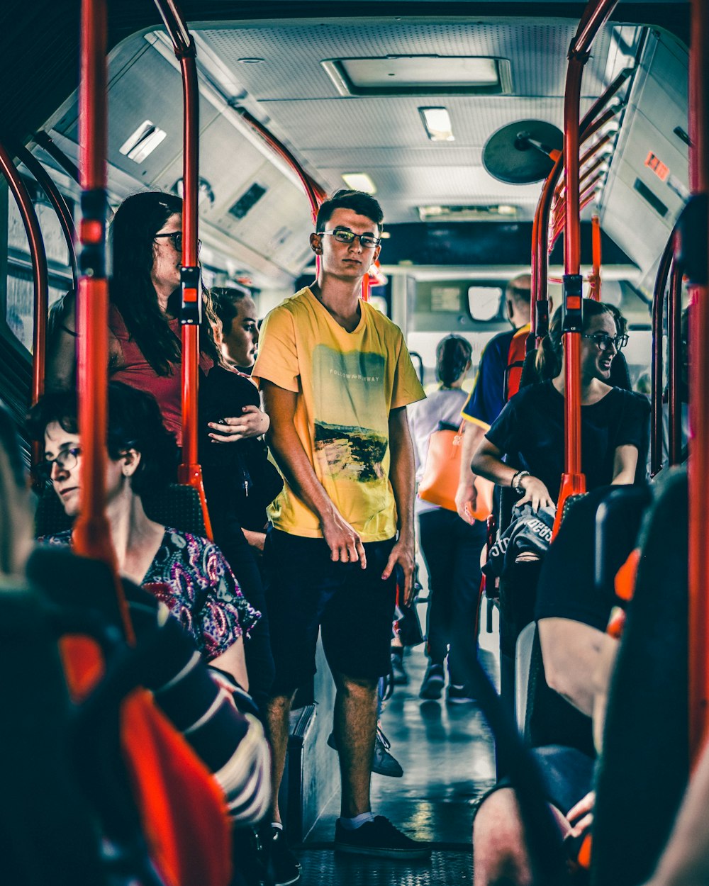 man wearing yellow shirt riding train