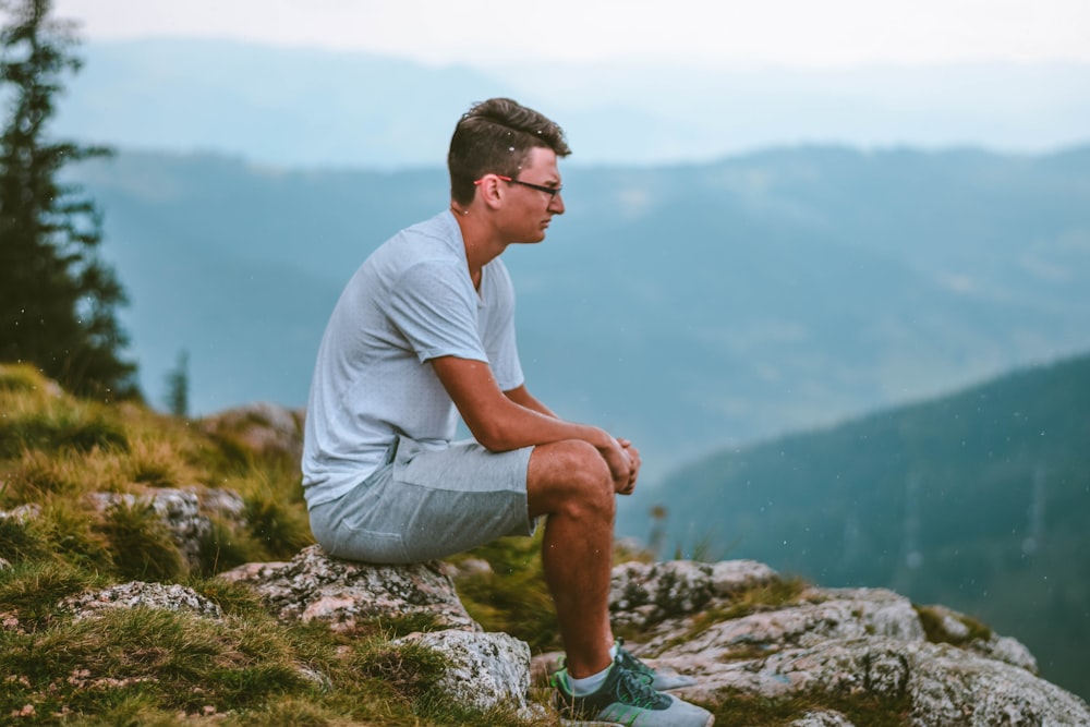 sitting man wearing white t-shirt