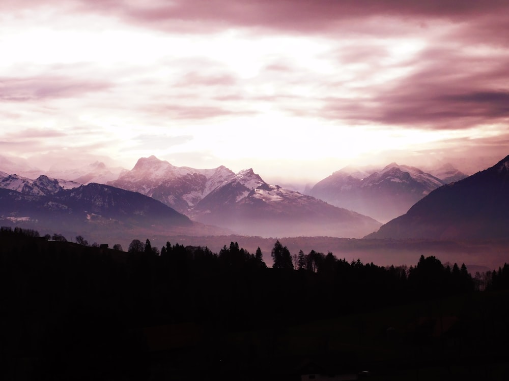 silhouette of mountain with fog