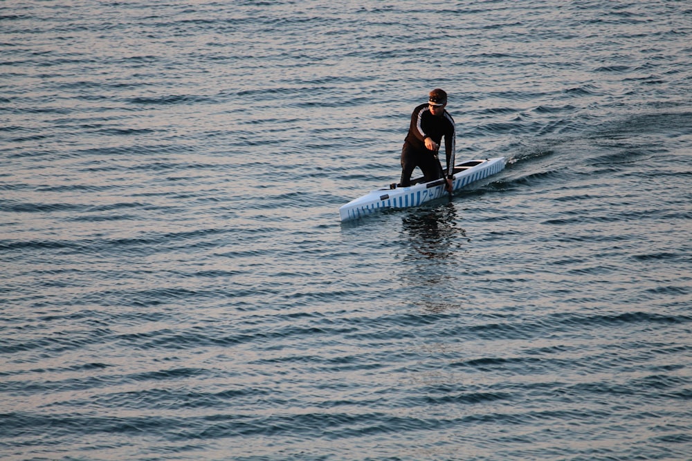 man riding on surfboard