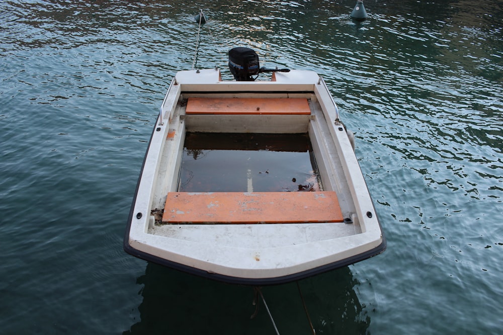white and brown boat on water