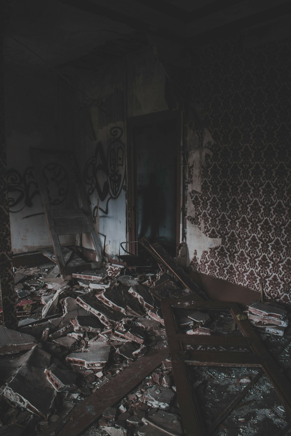 man near the doorway of an abandoned buidling