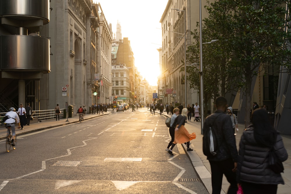 people walking on sidewalk between buildings